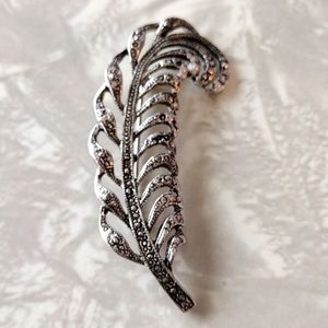 Beautiful faux silver feather brooch.